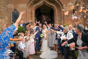 bride and groom confetti shot outside church