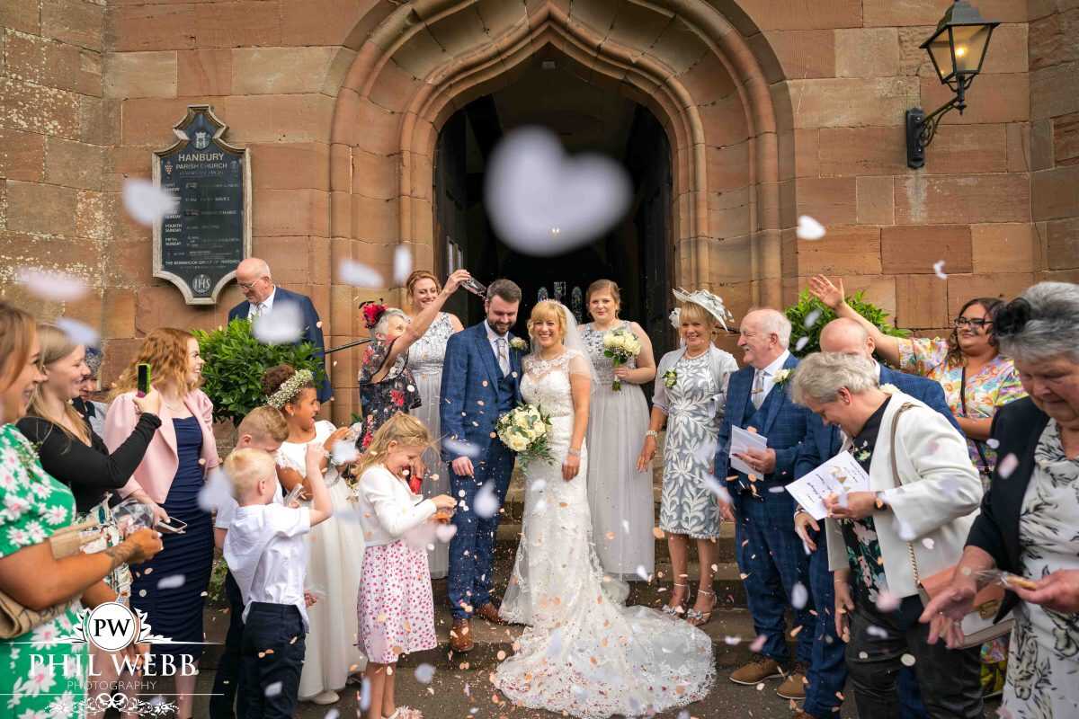 bride and groom confetti shot outside church